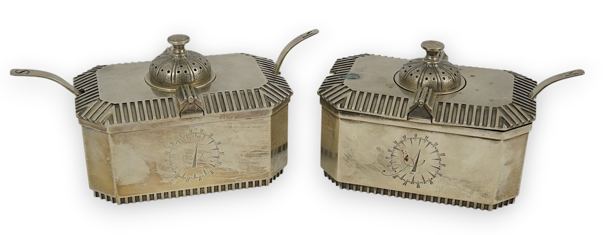 A pair of Elizabeth II silver double lidded condiments and matching spoons, by Hennell, Frazer & Haws